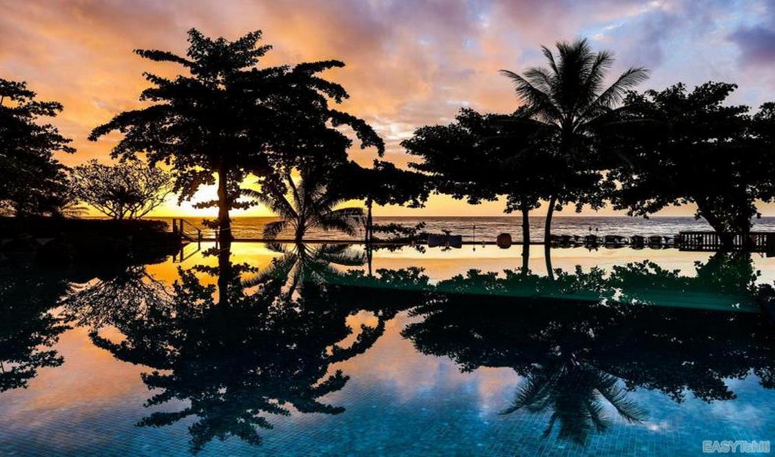 sunset by en hotel pool in Tahiti, French Polynesia
